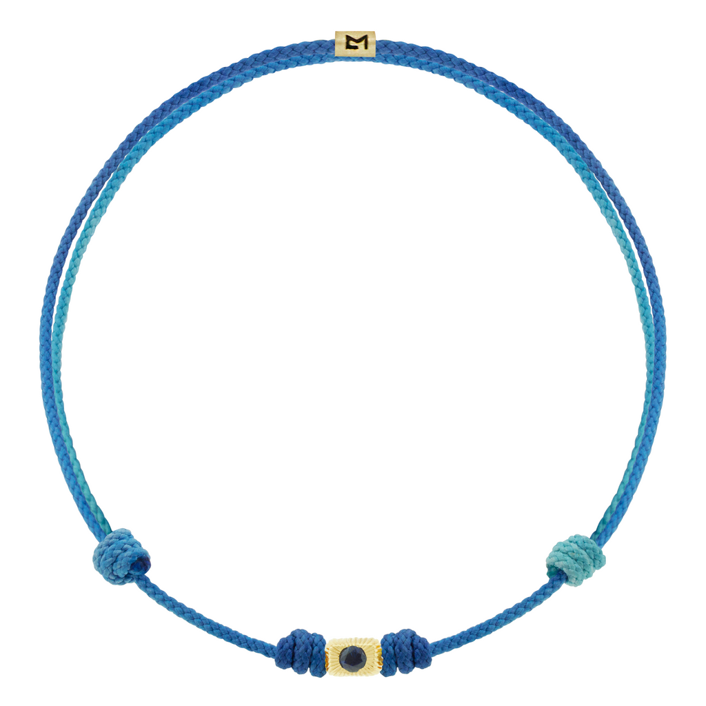 LUIS MORAIS 14k yellow gold small corrugated ingot with a blue sapphire on a cord bracelet