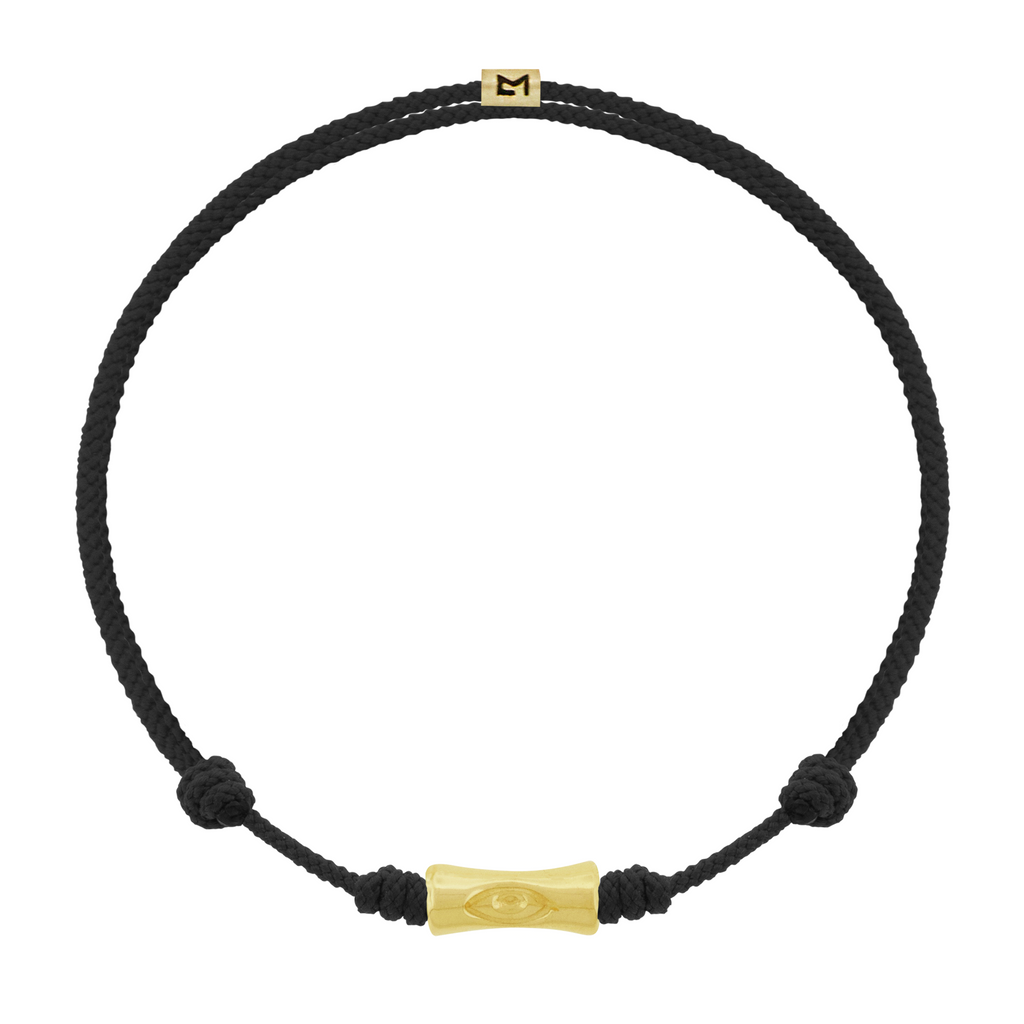 LUIS MORAIS 14k yellow gold single Sheath Bamboo tube with a recessed symbol on a an adjustable cord bracelet. The evil eye is a symbol of protection, believed to ward off negative energy and bring good fortune.