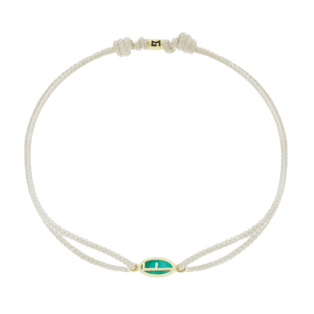 LUIS MORAIS 14k yellow gold framed initial oval with a gemstone backing on a cord bracelet. Make this bracelet uniquely yours by choosing your initial and cord color below!