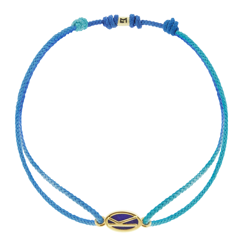 LUIS MORAIS 14k yellow gold framed initial oval with a gemstone backing on a cord bracelet. Make this bracelet uniquely yours by choosing your initial and cord color below!